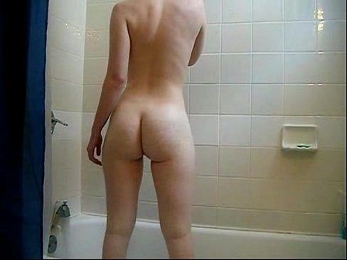 Mature woman standing nude in bathroom